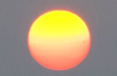 Sunset through wildfire smoke, with sunspots