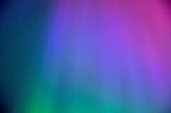 This is an aurora picture that shows a gradient of aurora colours from red through to purple, blue and then green